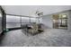 Enclosed patio with stone flooring, ceiling fans, and outdoor kitchen at 1003 Nathan Ridge Rd, Clermont, FL 34715