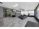 Covered patio featuring stone floors, ceiling fan, skylight, and sliding door access at 1003 Nathan Ridge Rd, Clermont, FL 34715