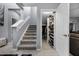 Carpeted staircase leading to the second floor with a closet for extra storage space at 1003 Nathan Ridge Rd, Clermont, FL 34715