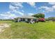 The backyard features a well-manicured lawn and patio area, perfect for outdoor entertaining and relaxation at 10453 Old Studio Rd, Clermont, FL 34711