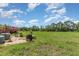 Spacious backyard featuring lush greenery, outdoor seating, and clear skies at 10453 Old Studio Rd, Clermont, FL 34711