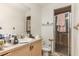 A bathroom featuring a single sink vanity and a glass-enclosed shower at 10453 Old Studio Rd, Clermont, FL 34711