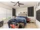 Bedroom with tiled floors, ceiling fan, and natural light from the window at 10453 Old Studio Rd, Clermont, FL 34711