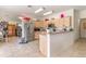 Open concept kitchen with stainless steel appliances and wooden cabinets at 10453 Old Studio Rd, Clermont, FL 34711