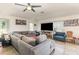 A bright living room features tile floors, modern furniture, and large windows at 10453 Old Studio Rd, Clermont, FL 34711