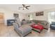 A spacious living room features tile floors, vaulted ceilings, and modern furniture at 10453 Old Studio Rd, Clermont, FL 34711