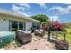 Outdoor patio area with a hot tub, outdoor seating, and a fire pit at 10453 Old Studio Rd, Clermont, FL 34711