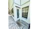 Backyard entrance featuring a white door with glass insert and a secure window with bars at 11714 Peachstone Ln, Orlando, FL 32821