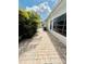 Backyard with privacy enhanced by lush tropical plants and foliage adjacent to a brick paver walkway at 11714 Peachstone Ln, Orlando, FL 32821