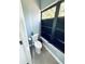 Cozy bathroom featuring modern toilet next to an artistic stained glass window at 11714 Peachstone Ln, Orlando, FL 32821