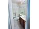 Well-lit bathroom with a shower, toilet, and a vanity with modern fixtures at 11714 Peachstone Ln, Orlando, FL 32821
