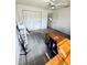 Comfortable bedroom with tile floors, ceiling fan, closet, and bonus desk at 11714 Peachstone Ln, Orlando, FL 32821