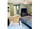 Comfortable bedroom with tiled floors, a modern crib, and stylish furnishings at 11714 Peachstone Ln, Orlando, FL 32821
