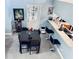 Dining area featuring a modern black table set, a stylish chandelier, and views to the kitchen counter with bar stools at 11714 Peachstone Ln, Orlando, FL 32821