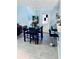 Dining room features a modern chandelier, seating for four, and a stylish bar area at 11714 Peachstone Ln, Orlando, FL 32821