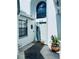 Charming front entrance with a well-maintained walkway, potted plants, and ample natural light at 11714 Peachstone Ln, Orlando, FL 32821