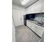 Compact kitchen featuring stainless steel appliances, ample cabinetry, and modern countertops at 11714 Peachstone Ln, Orlando, FL 32821