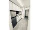 Compact kitchen featuring stainless steel appliances, ample cabinetry, and modern countertops at 11714 Peachstone Ln, Orlando, FL 32821