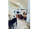 Open-concept living room with high ceilings, staircase, tile flooring, and a comfortable seating area with recliners at 11714 Peachstone Ln, Orlando, FL 32821
