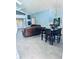 Open-concept living area with tile flooring, comfortable seating, dining table, chandelier, and bright, airy atmosphere at 11714 Peachstone Ln, Orlando, FL 32821