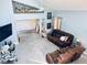 Bright living room featuring tile floors, a comfortable brown sofa set, and natural light from the open layout at 11714 Peachstone Ln, Orlando, FL 32821