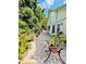 Paver patio with beautiful greenery and plant decor next to the house with easy access at 11714 Peachstone Ln, Orlando, FL 32821