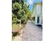 Paver patio next to lush greenery featuring a birdhouse, potted plants, and access to the home at 11714 Peachstone Ln, Orlando, FL 32821