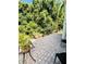 Paver patio next to lush greenery featuring potted plants, seating, and access to the home at 11714 Peachstone Ln, Orlando, FL 32821