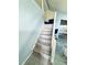 Stylish staircase featuring tile steps and railing, leading to the upper level at 11714 Peachstone Ln, Orlando, FL 32821