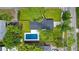 Birds eye view of modern home with in-ground pool, well manicured lawn and mature landscaping at 1201 Manchester Rd, Maitland, FL 32751