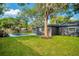 Exterior backyard featuring in-ground pool, mature trees and well maintained lawn at 1201 Manchester Rd, Maitland, FL 32751
