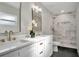 Modern bathroom featuring dual sinks, marble walk-in shower, and white cabinets at 1201 Manchester Rd, Maitland, FL 32751