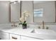 Bathroom features double vanity, white countertops and decorative flower display at 1201 Manchester Rd, Maitland, FL 32751