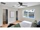 Serene bedroom featuring hardwood floors, a modern ceiling fan, and a view of the pool at 1201 Manchester Rd, Maitland, FL 32751