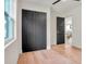 Bedroom with black closet doors and hardwood floors, leading into the recently renovated kitchen at 1201 Manchester Rd, Maitland, FL 32751