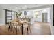 Bright dining area features an adjacent, modern kitchen and a rustic wood table with seating for six at 1201 Manchester Rd, Maitland, FL 32751