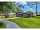 View of the house showing garage, driveway, lawn and dark exterior paint with wood accents at 1201 Manchester Rd, Maitland, FL 32751