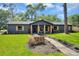 Inviting home featuring a landscaped front yard and stylish craftsman columns with wood accents at 1201 Manchester Rd, Maitland, FL 32751