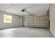 Spacious garage featuring a large garage door and window at 1201 Manchester Rd, Maitland, FL 32751
