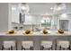 Bright, white kitchen with marble backsplash, modern appliances, and bar seating at 1201 Manchester Rd, Maitland, FL 32751