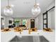 Open concept view from the kitchen features modern finishes and seamless transition into the dining and living areas at 1201 Manchester Rd, Maitland, FL 32751