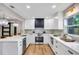 Stylish kitchen with white cabinets, modern appliances, and wood look floors at 1201 Manchester Rd, Maitland, FL 32751