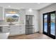 Modern kitchen with direct access to the pool area, stainless steel refrigerator, and sleek countertops at 1201 Manchester Rd, Maitland, FL 32751