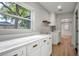 Laundry room with bright countertops, cabinets, and window view to outside at 1201 Manchester Rd, Maitland, FL 32751