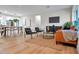 Bright open-concept living room with dining area, modern furnishings, and hardwood floors at 1201 Manchester Rd, Maitland, FL 32751
