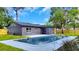 Modern home with swimming pool, lush lawn and landscaping, shot at daytime at 1201 Manchester Rd, Maitland, FL 32751