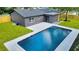 Aerial view of a home with a modern pool and well-manicured lawn at 1201 Manchester Rd, Maitland, FL 32751