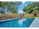 Swimming pool surrounded by wood fence and landscaped yard at 1201 Manchester Rd, Maitland, FL 32751