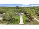 Aerial view of the property showing the home, driveway, and surrounding trees at 13101 Sw 85 Pl, Dunnellon, FL 34432