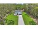 Aerial view of the house showcasing a long driveway and surrounding greenery at 13101 Sw 85 Pl, Dunnellon, FL 34432